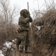 Ukrainian Military Forces serviceman watches through spyglass in a trench on the frontline with Russia-backed separatists near Avdiivka, southeastern Ukraine, on January 9, 2022.